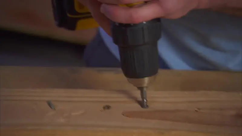 The extraction end backing a screw out of the board